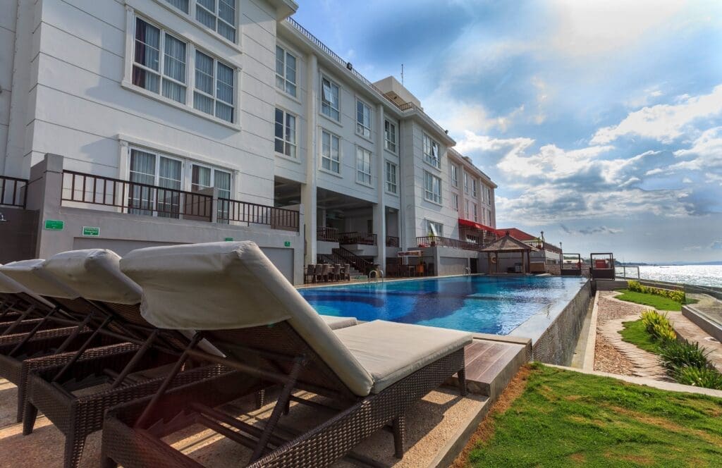 The white hotel facade and pool at hotel on the rock kupang